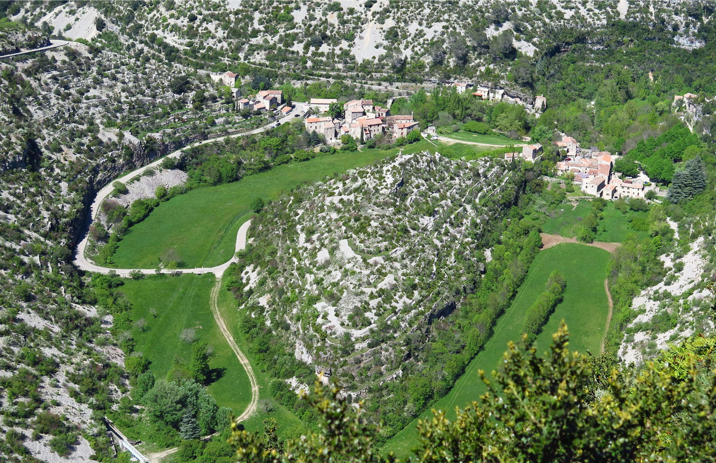 Aerial of Cirque de Navacelles in the Hérault — limestone scree, garrigue-enclosed green valley.
