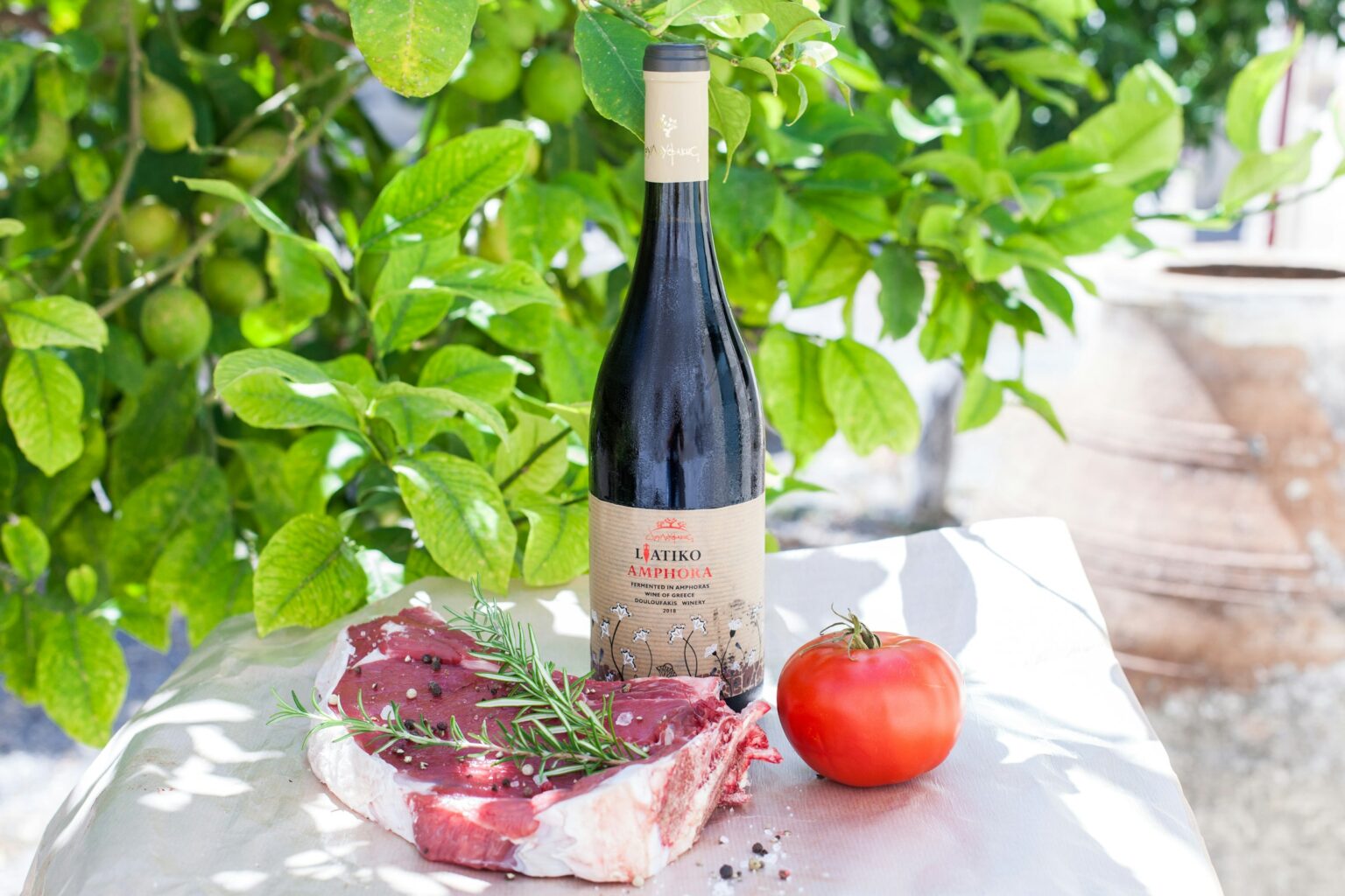 The Tannin-Fat Equation: Why Steak Asks For Cabernet (And Pinot Noir Disappoints) A well-marbled ribeye steak with red wine, illustrating the tannin-fat chemistry behind the steakhouse Cabernet pairing.