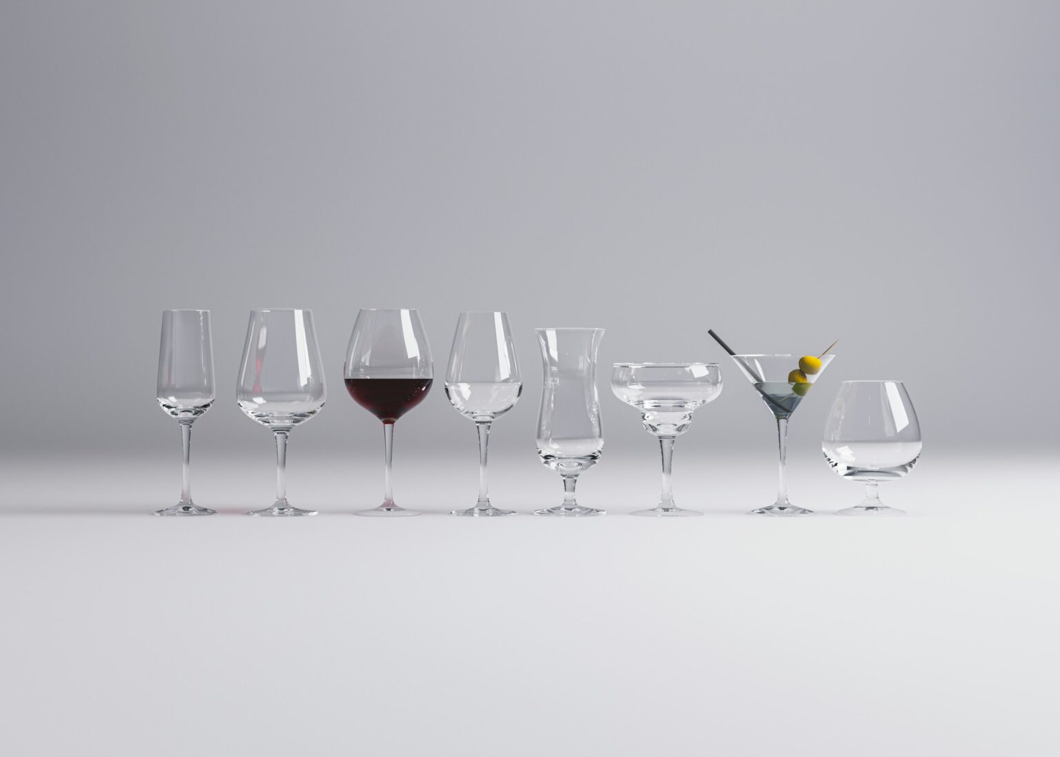 The Glass Matters (More Than You’d Think): What Riedel’s Research Actually Proves A row of wine glasses sitting next to each other on a table, illustrating the comparison of wine glass shapes that the Riedel research and sniff-cam studies actually proves.